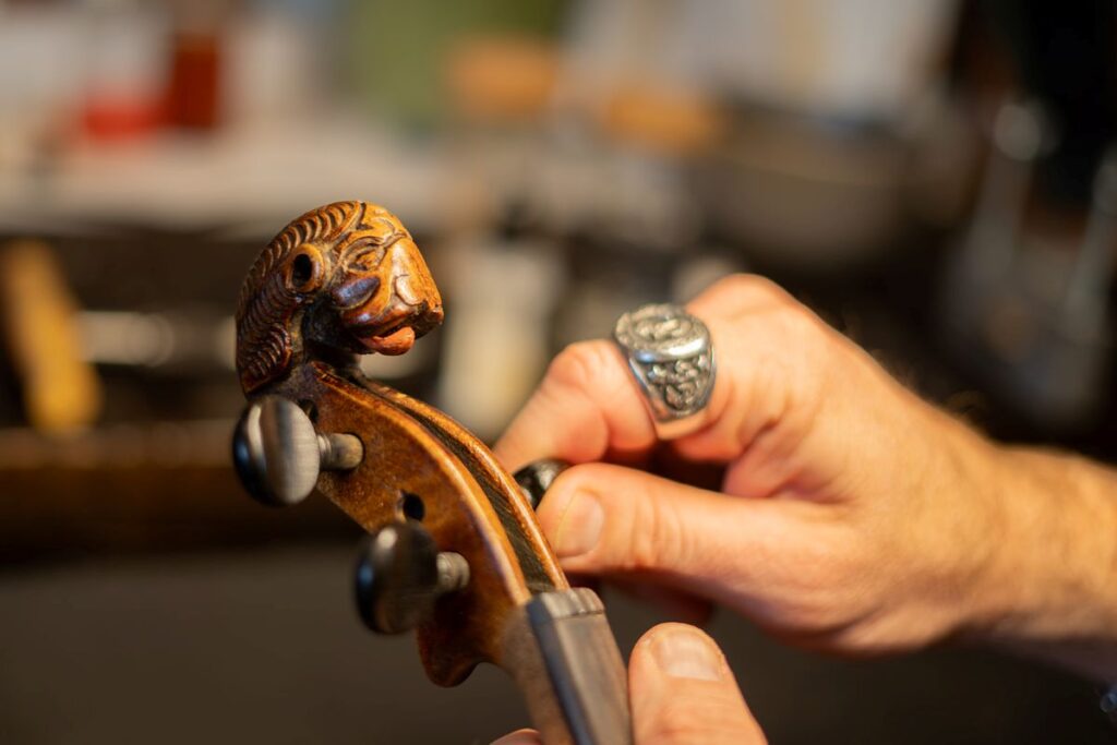 Luthier Repairing old violin pegs.