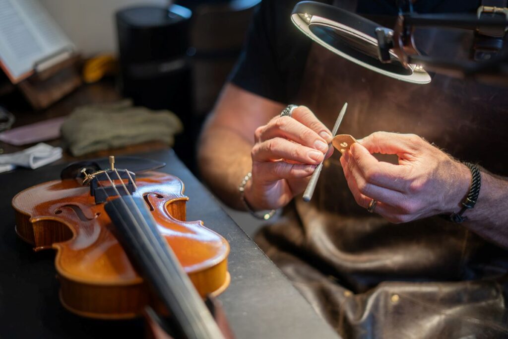 St. George Luthier Working on Violin Bridge.