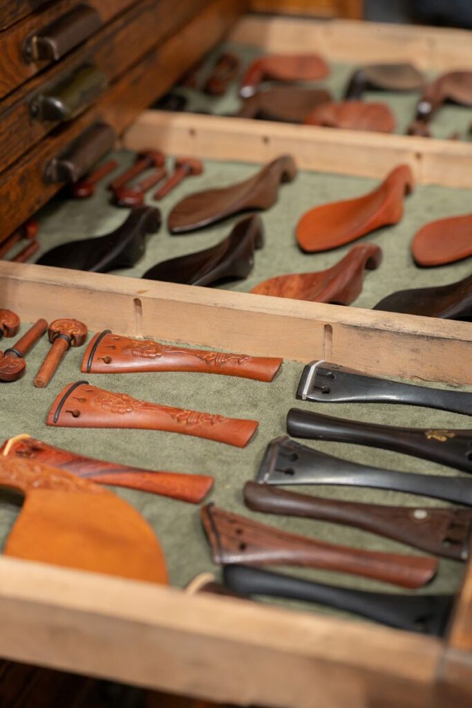 Drawer of Violin tailpieces, chinrests, pegs for the violin body.
