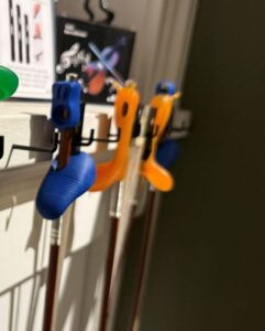 Violin bow grips on multiple violins in shop.